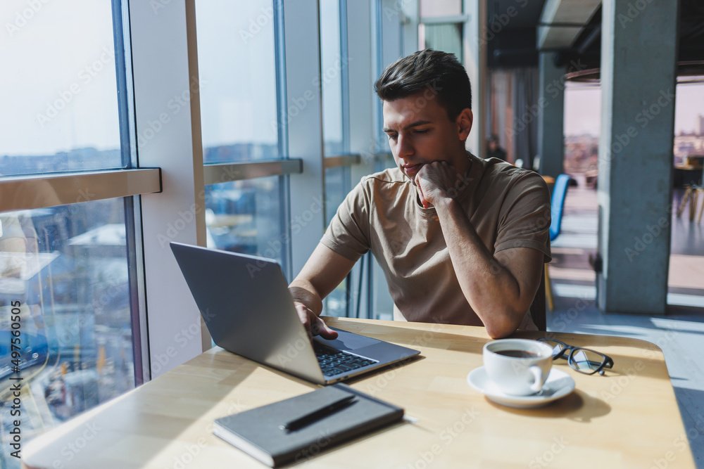 A person working on a laptop with a coffee cup, representing a blogger in action - how to make money blogging