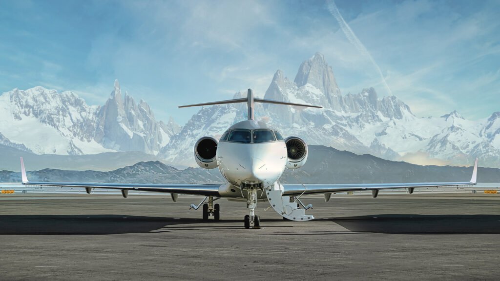 A Villiers Jet Private jet waiting to be boarded on runway with snowy mountains in the background - rent a private jet