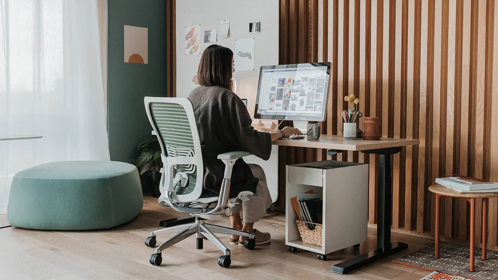 A clean and aesthetically pleasing home office — desk, laptop, plant, natural light — to show what a productive workspace looks like - remote working jobs