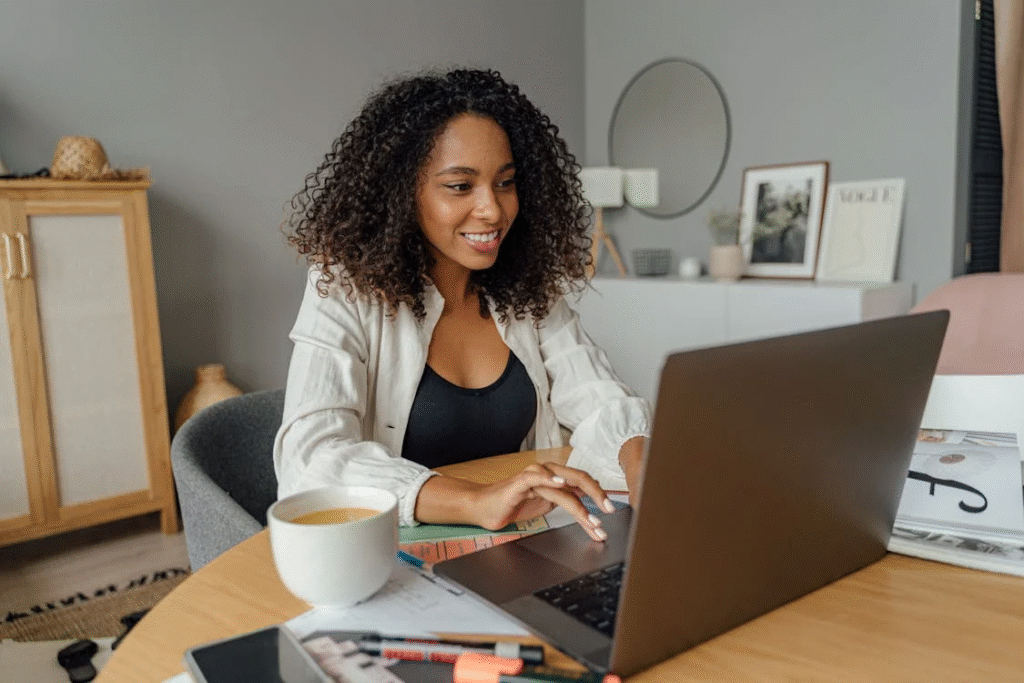 A young professional working from a cozy home office setup with a laptop and coffee mug — symbolizes freedom and modern work life - remote working jobs
